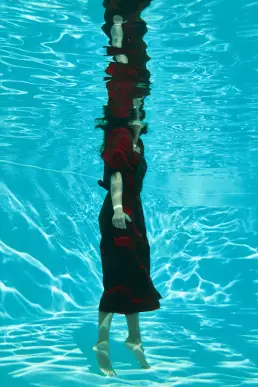 woman red dress underwater editorial