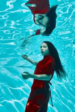 woman red dress underwater editorial